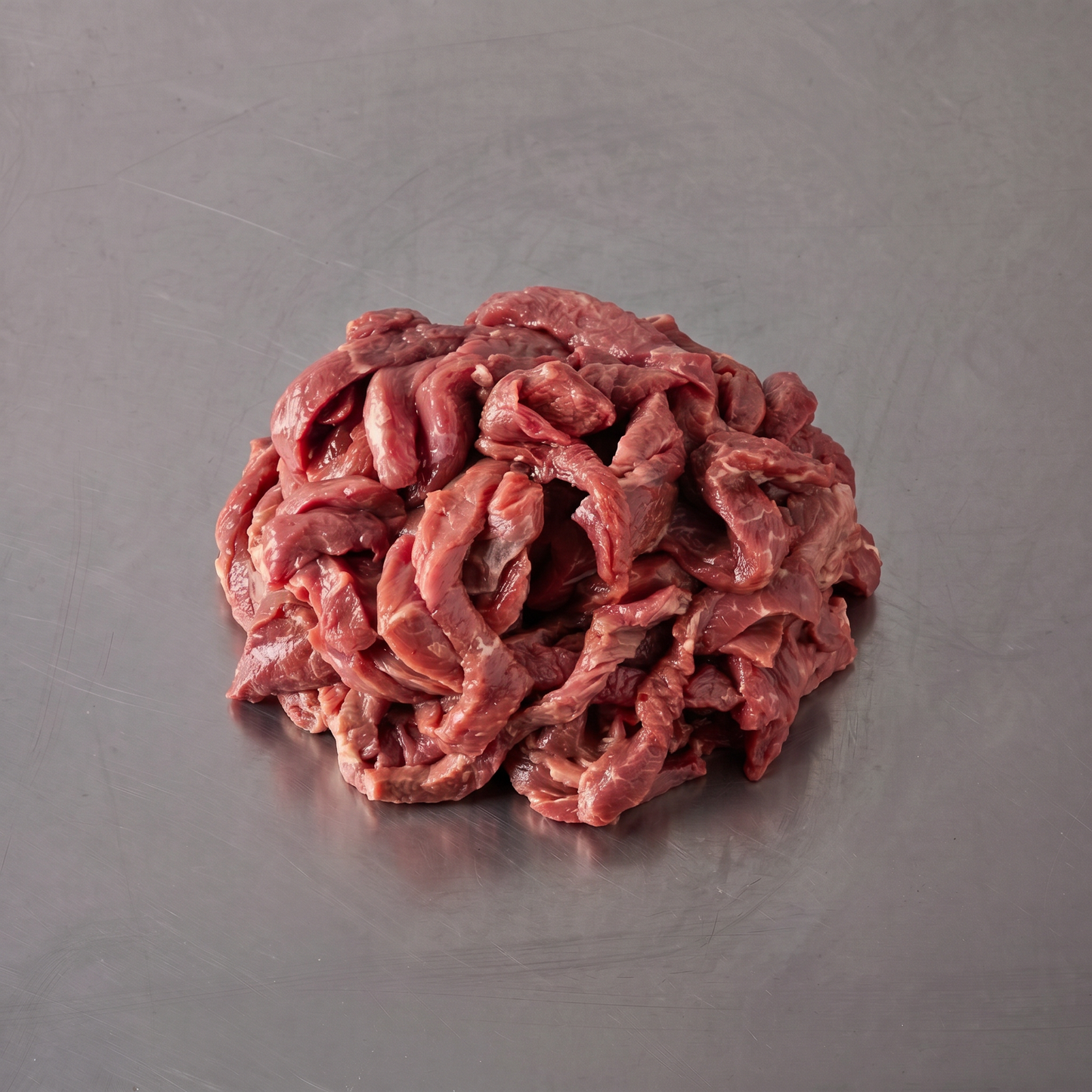 Grass Fed Stir Fry Strips ~500g on stainless steel butcher's bench