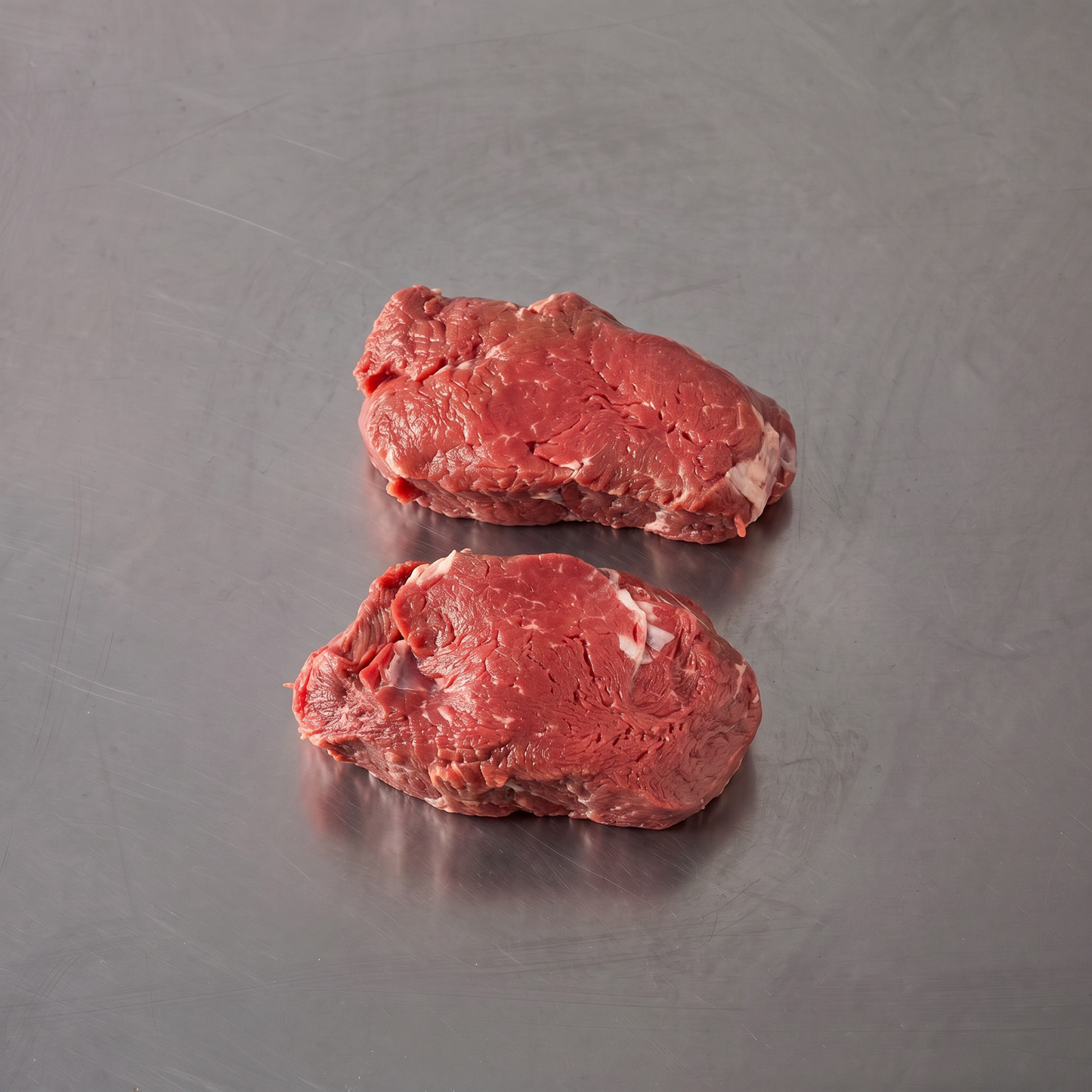 Grass Fed Eye Fillet steaks on stainless steel butcher's bench