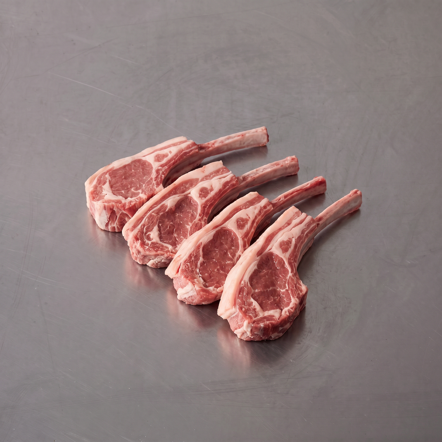 Grass Fed Lamb Cutlets ~500g on stainless steel butcher's bench