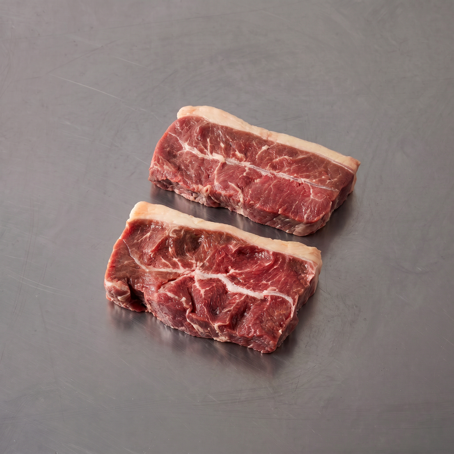 Grass Fed Flank/Oyster Blade ~500g on stainless steel butcher's bench