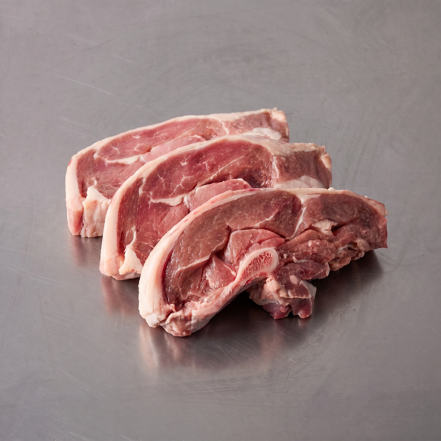 Grass Fed Lamb Chump Chops ~600g on stainless steel butcher's bench