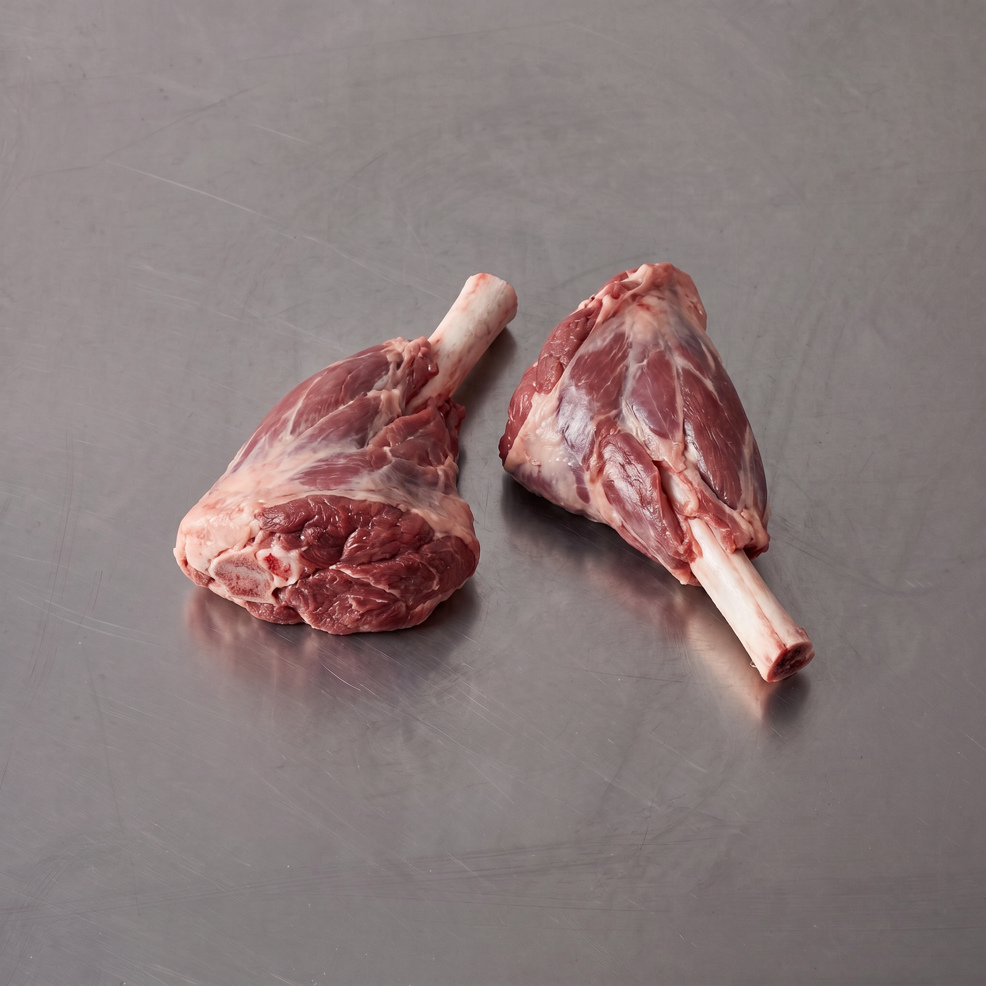 Grass Fed Lamb Shank ~600g on stainless steel butcher's bench