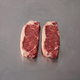 Grass Fed NY Sirloin ~500g on stainless steel butcher's bench