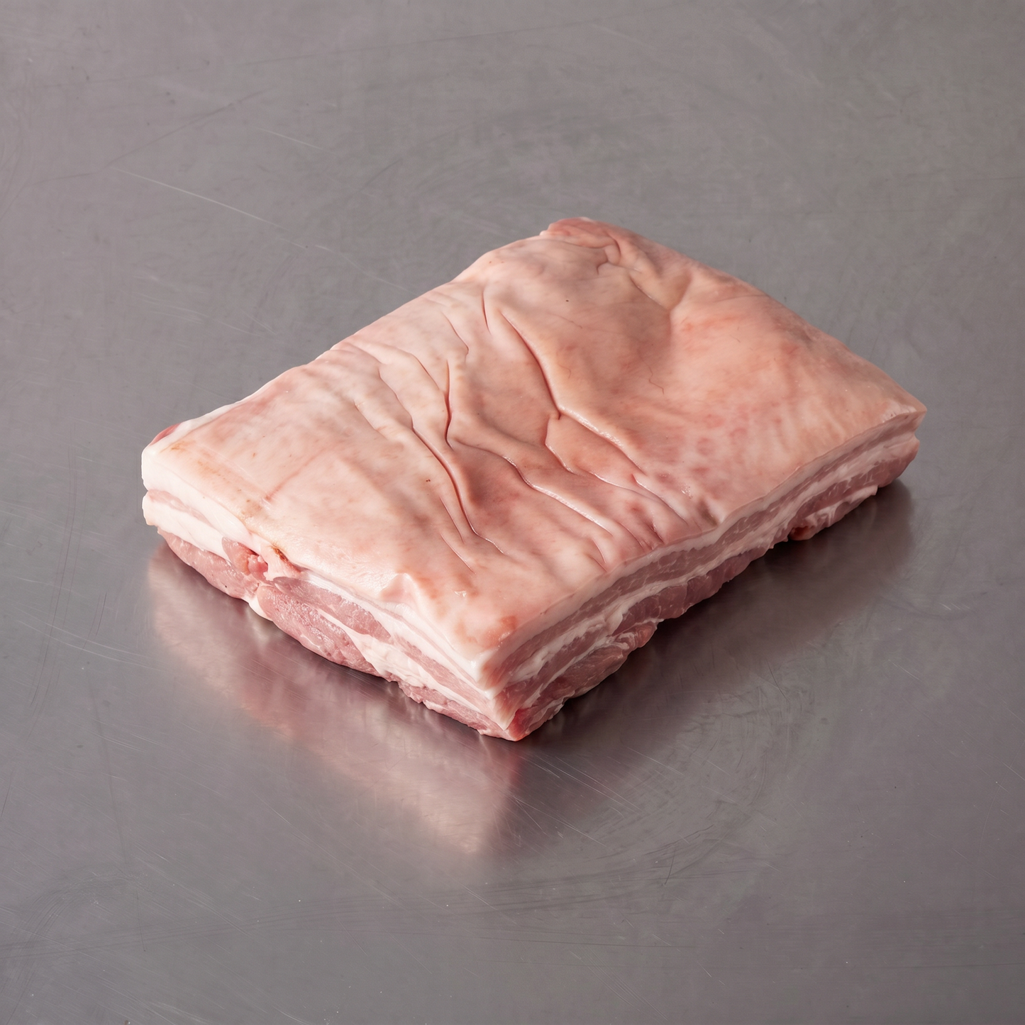 Free Range Pork Belly Roast ~1kg on stainless steel butcher's bench