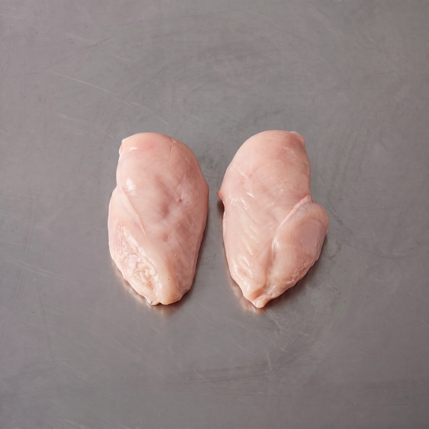 Free Range Chicken Breast Fillets ~1kg on stainless steel butcher's bench