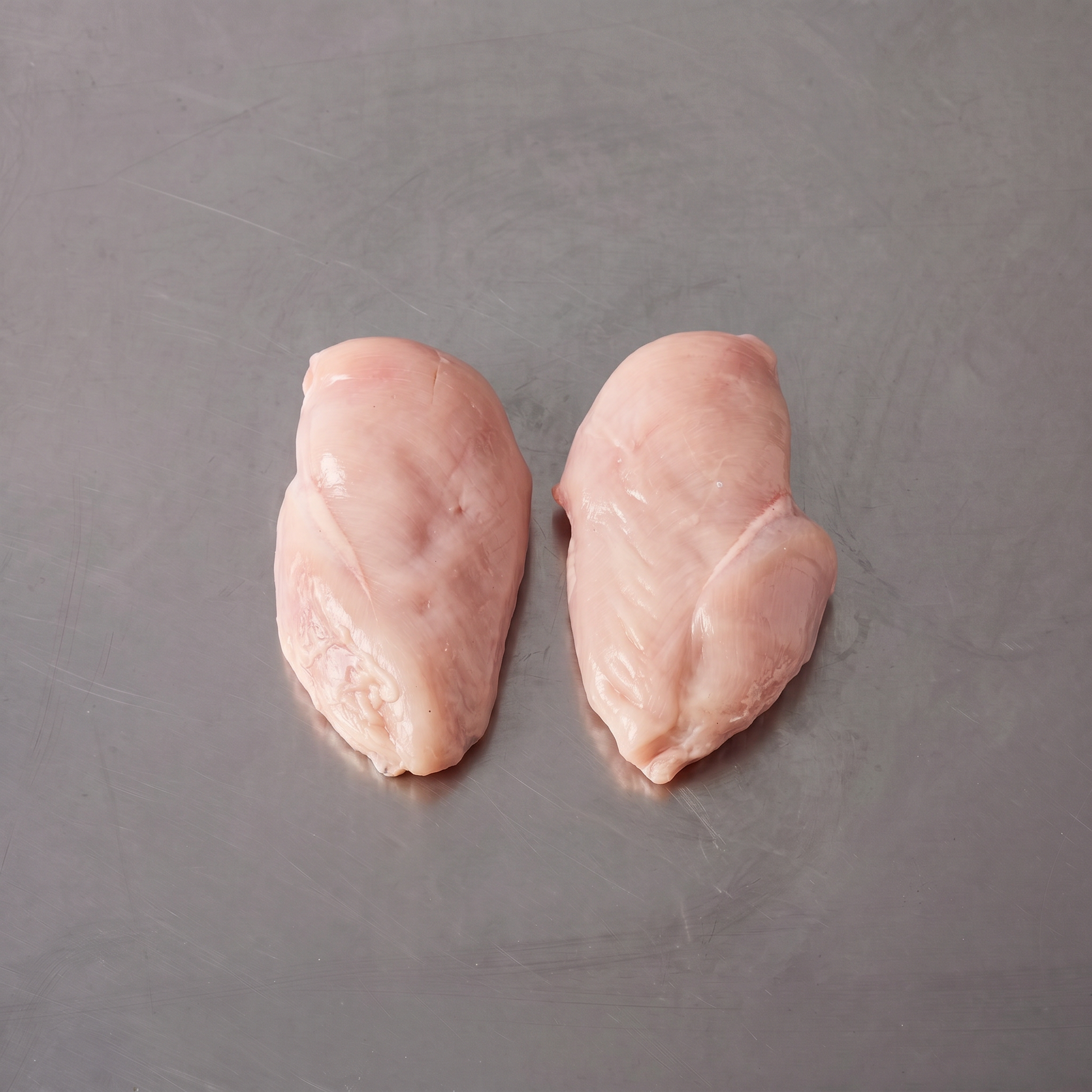 Free Range Chicken Breast Fillets ~1kg on stainless steel butcher's bench
