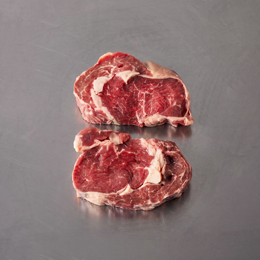 Grass Fed Scotch Fillet ~500g on stainless steel butcher's bench